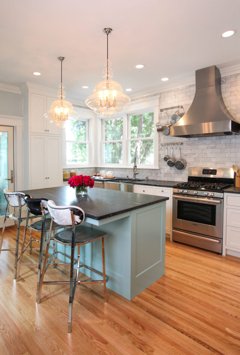 Twin Cities kitchen remodel offers blue island, white cabinets, stainless appliances.