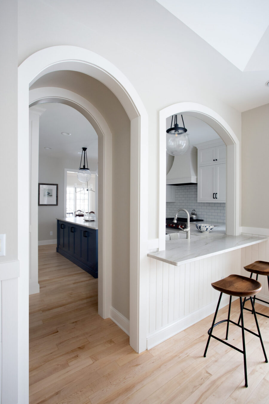 Luminous Twin Cities design-build kitchen remodel incorporates spacious arched passageways.