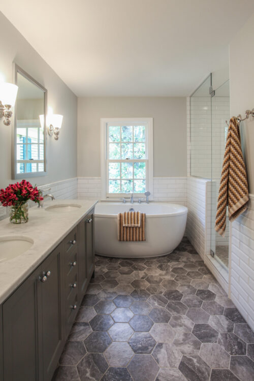 Twin Cities bathroom remodel reveals freestanding tub, dual vanity, and glass shower.