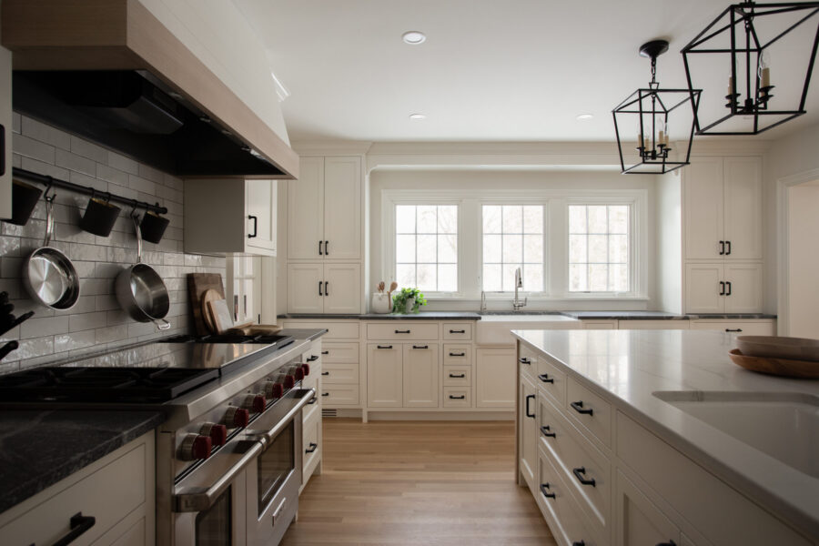 Twin Cities kitchen remodel: white cabinetry, dark granite, wood, black lanterns.