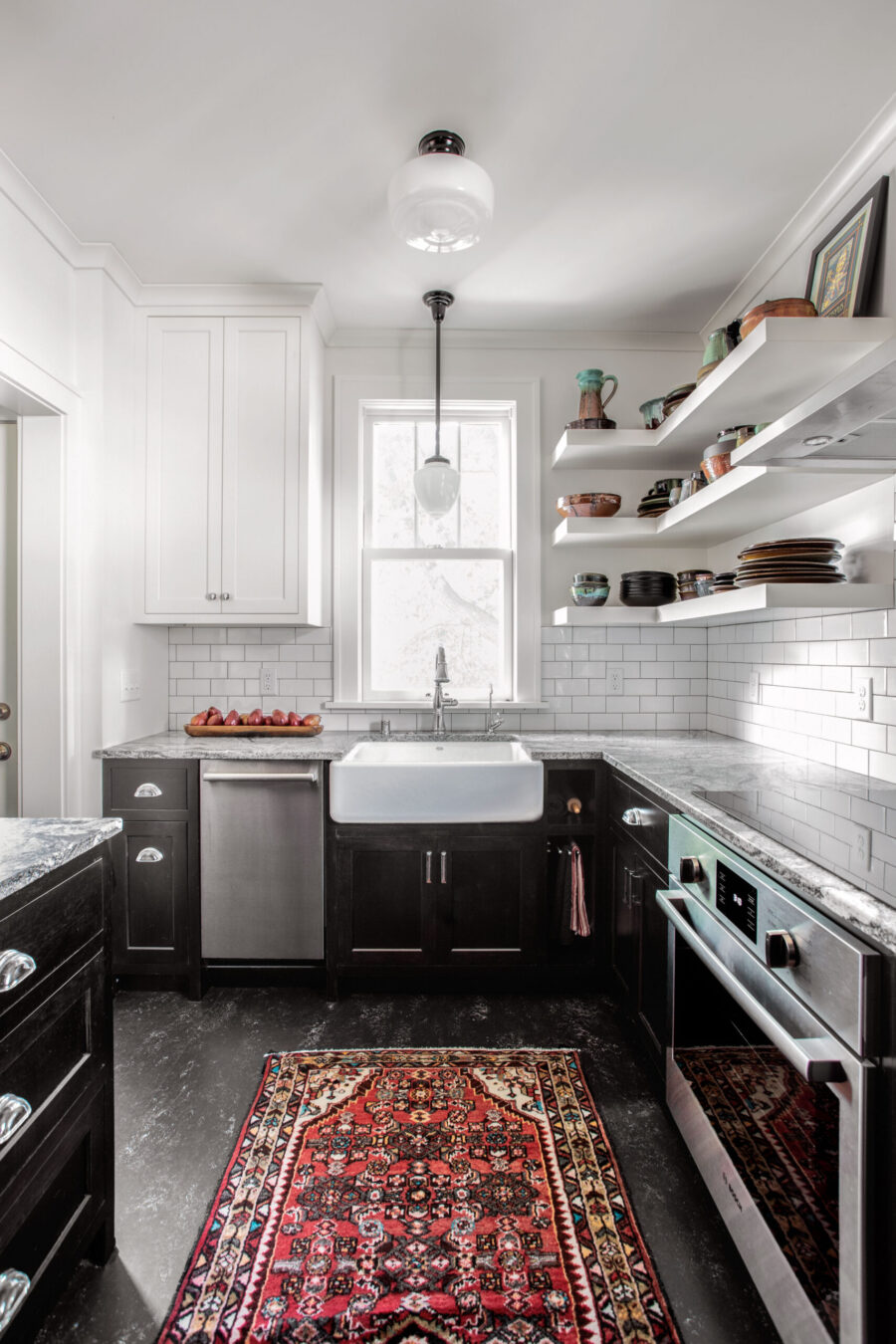 Twin Cities kitchen renovation features two-tone cabinetry, a farmhouse sink, and bright lighting.