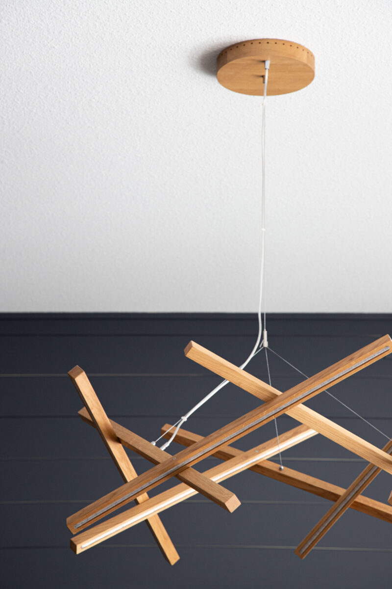 Architectural design-build renovation features a custom geometric wood LED pendant lighting.