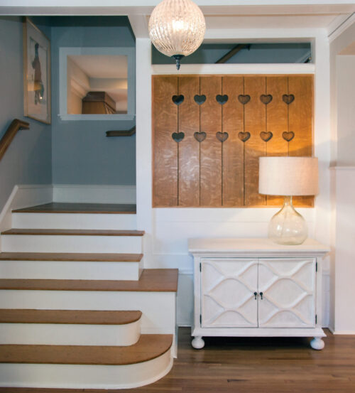 Antiqued-finish millwork features heart-paneled wainscot and quarter-sawn hardwood stairs