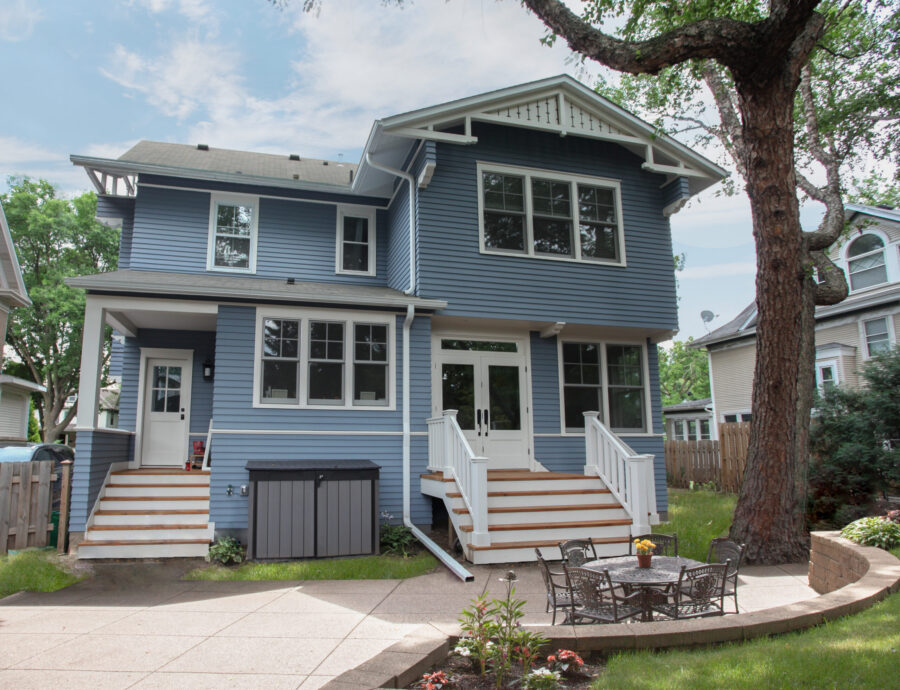 Extensive renovation modernized blue home; new siding, custom stairs, patio, retaining-wall.