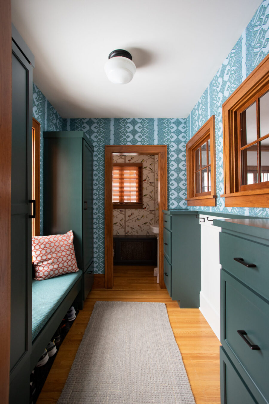 This Twin Cities home renovation creates teal cabinetry, patterned wallpaper, wood trim.