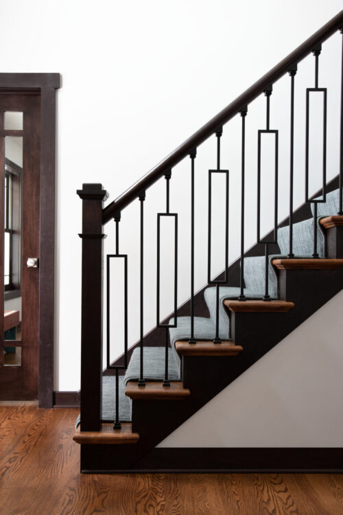 Renovation provides dark-wood-staircase, geometric-metal-balusters, light-runner, hardwood floor. Twin-Cities.