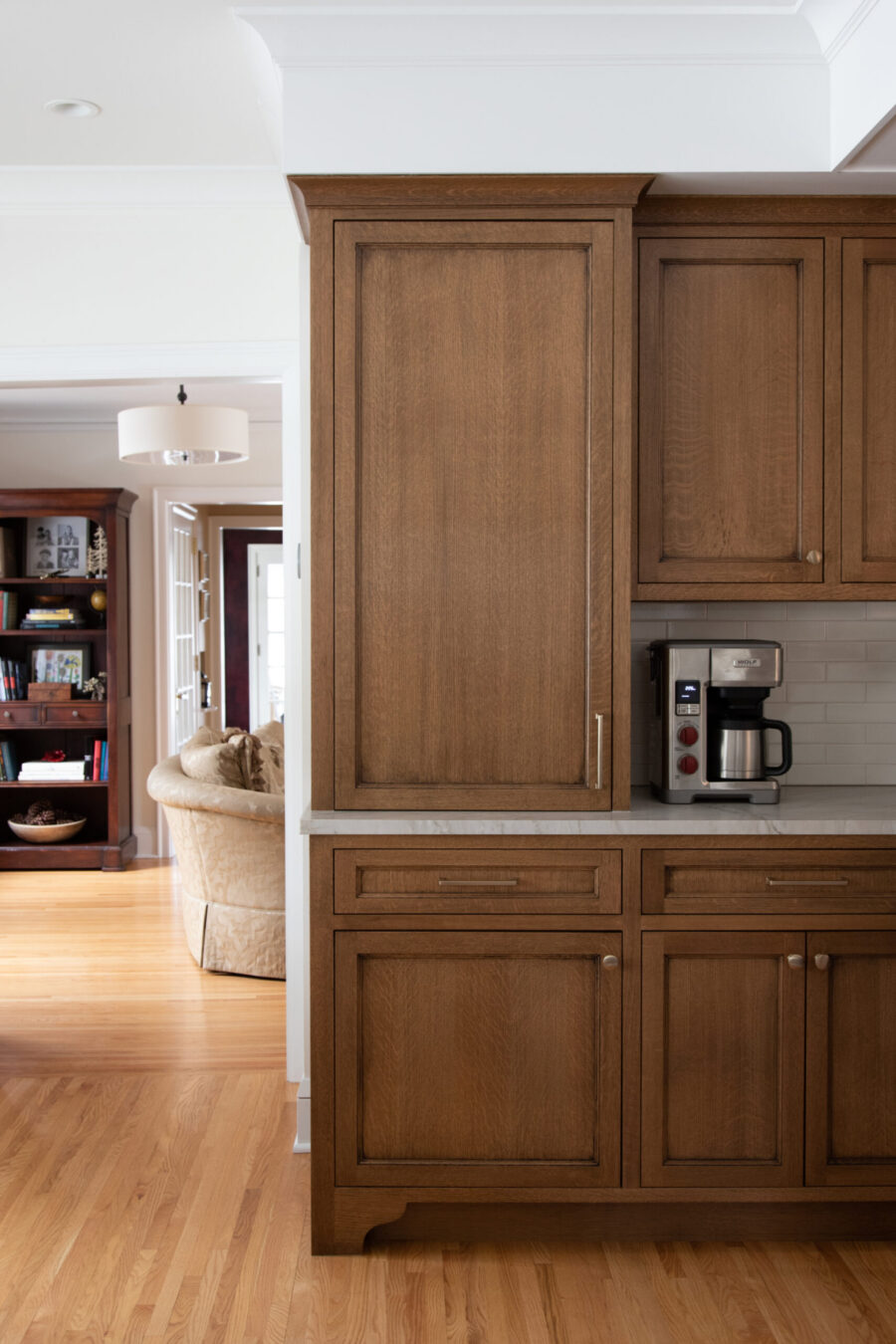 Twin Cities kitchen remodel features custom wood cabinets, marble counters, and subway tile.