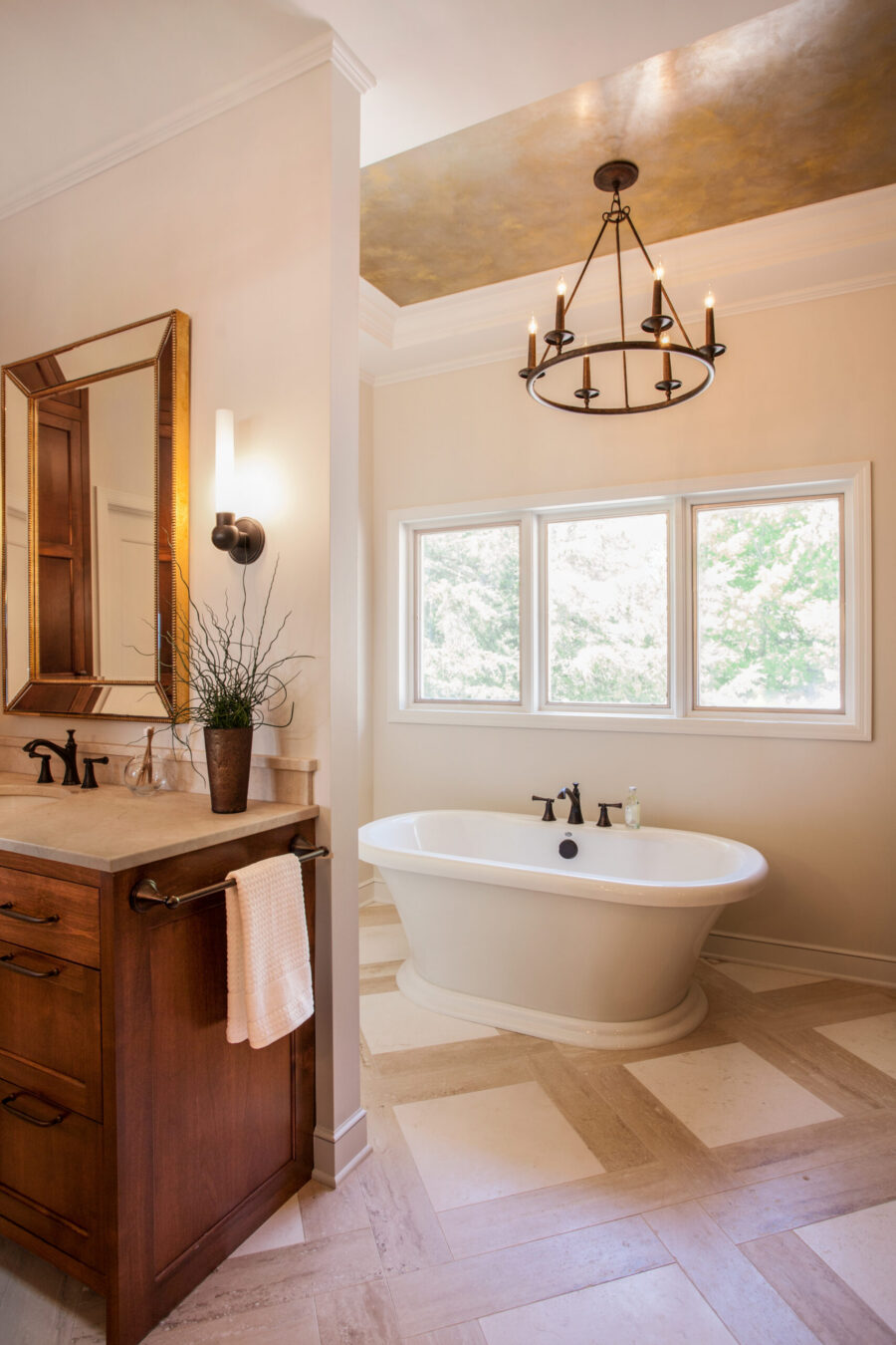 Luxurious freestanding bathroom remodel, Twin Cities. Features cabinetry, chandelier.