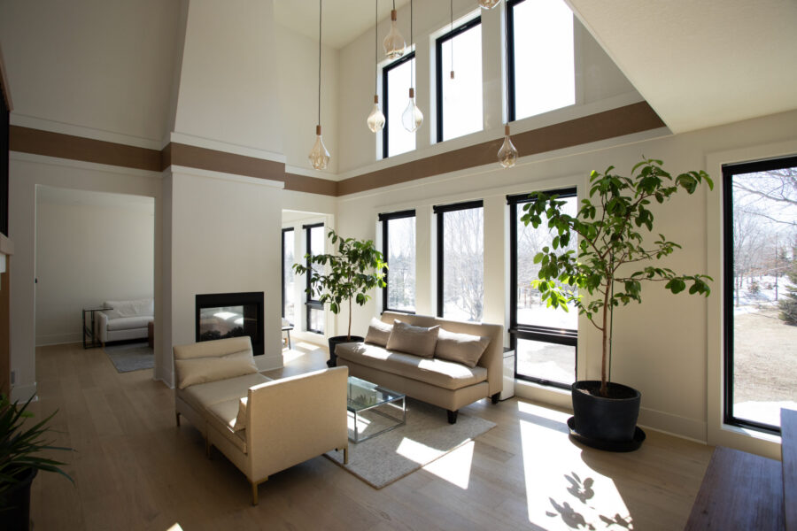 Twin Cities design build illuminates vaulted architecture, expansive windows, floors.