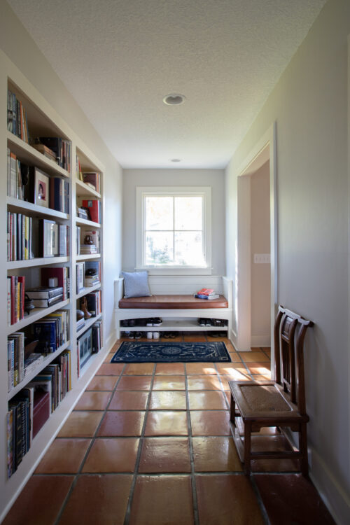Entryway features built-in-bookshelves, window-bench, terracotta-tiles; natural-light; home-remodel, Twin-Cities.