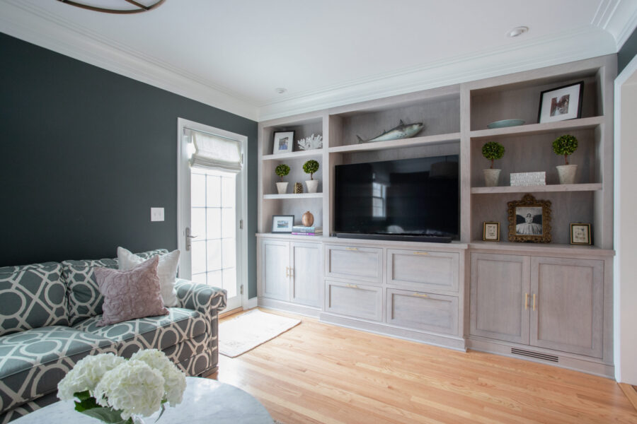 Expansive architectural cabinetry custom-built for media storage brightens this living area.