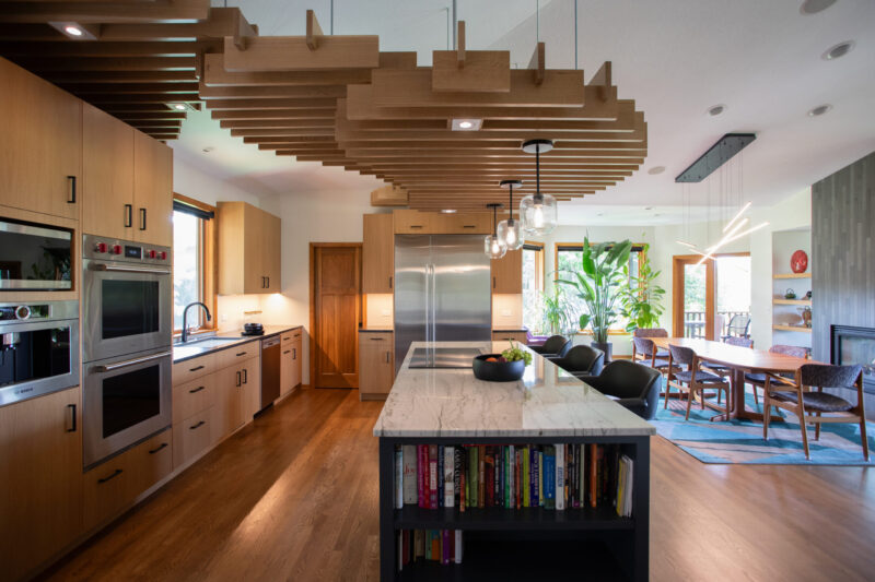 Twin Cities kitchen remodel; light wood, large marble island, wood ceiling slats.