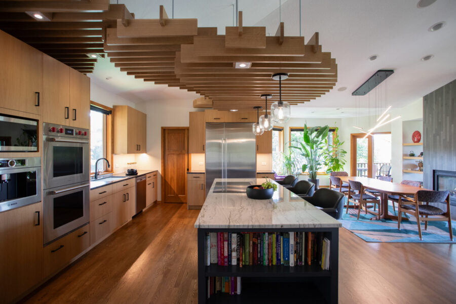 Twin Cities kitchen remodel; light wood, large marble island, wood ceiling slats.