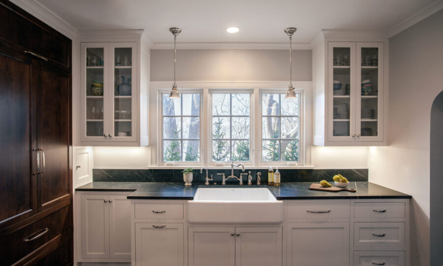 Twin Cities kitchen renovation: white cabinetry, dark countertops, farmhouse sink.