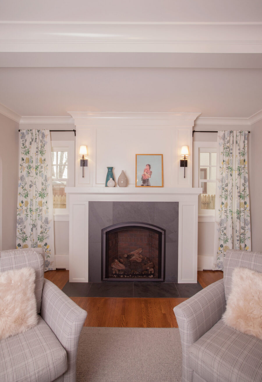 Luxurious Twin Cities home renovation integrates a distinct white paneled fireplace design.