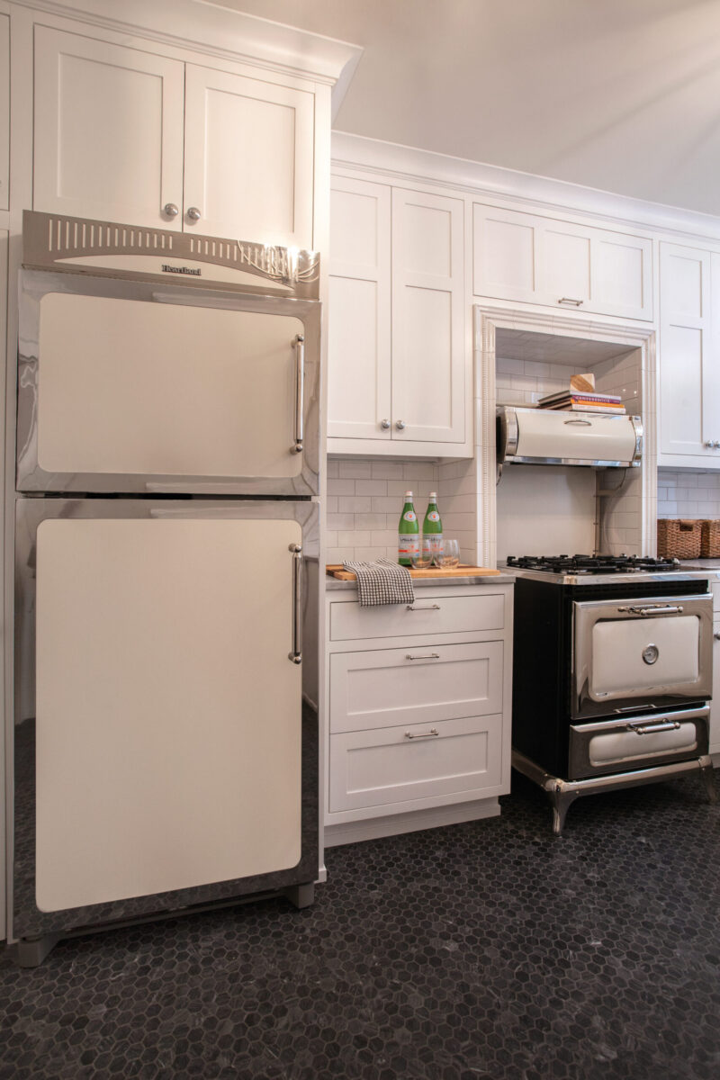 Twin Cities kitchen remodel features white shaker cabinets, vintage refrigerator, dark hexagon floor.
