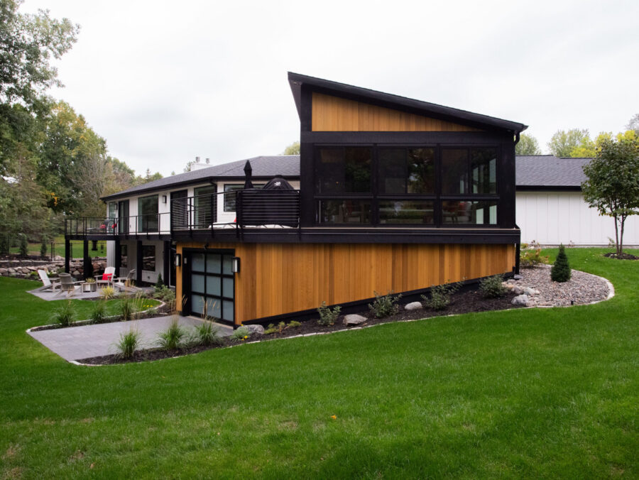Modern multi-level design-build residence features wood, white, black exterior finishes.