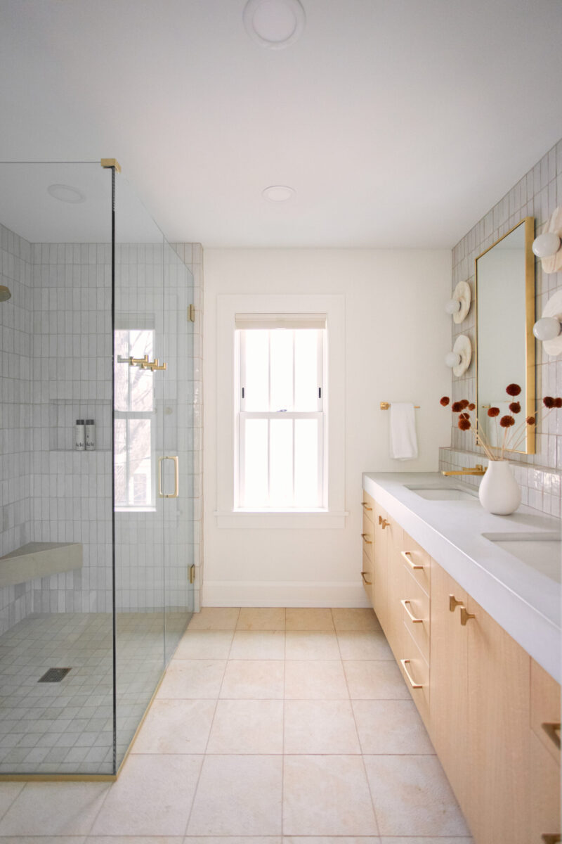 Twin Cities bathroom renovation details modern light wood vanity, large tiled shower.