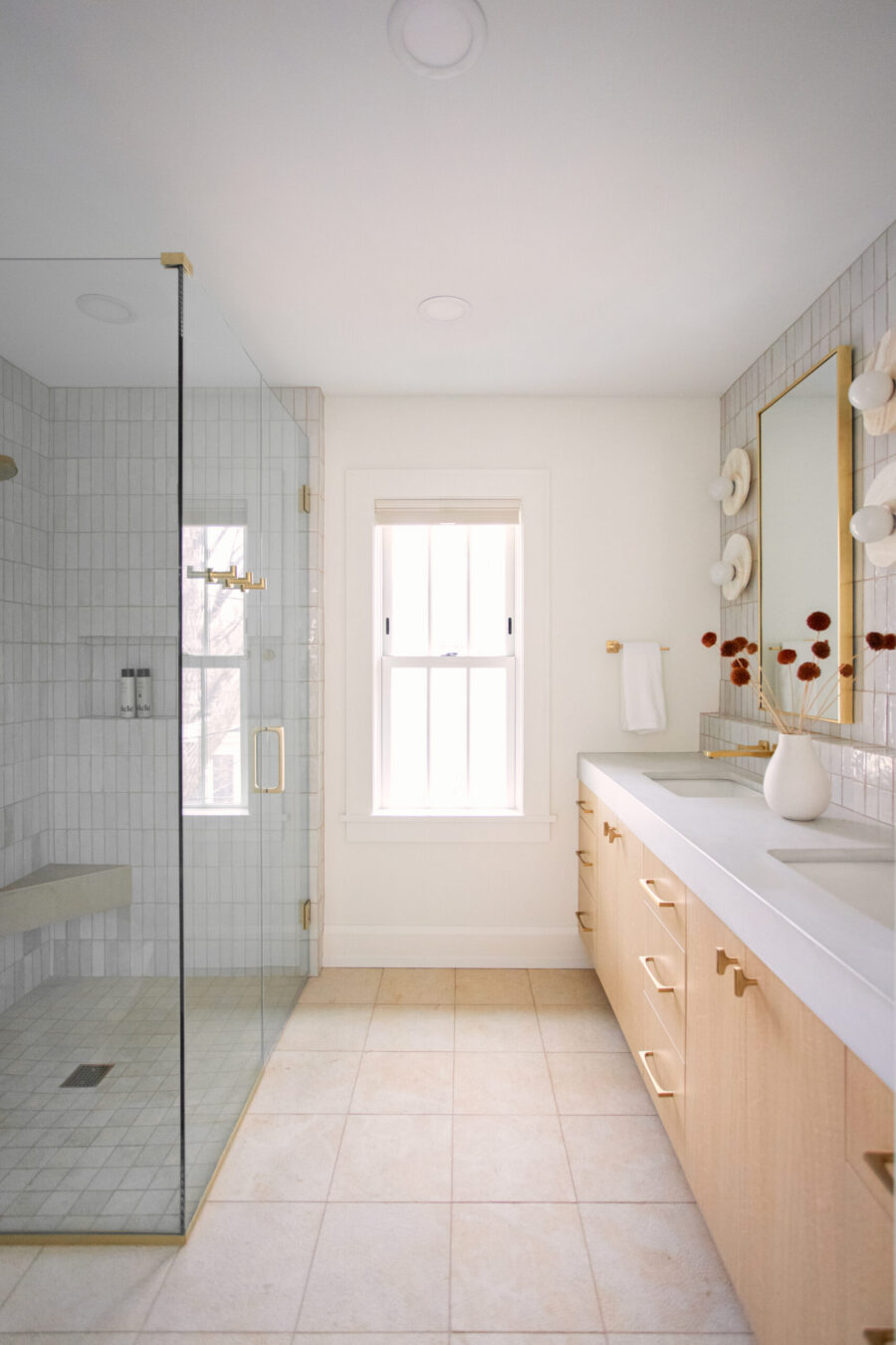 Twin Cities bathroom renovation details modern light wood vanity, large tiled shower.