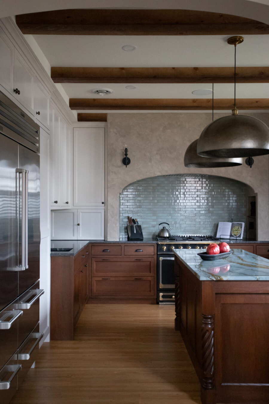 Twin Cities kitchen remodel combines bright white, rich wood, stainless, arched tile.