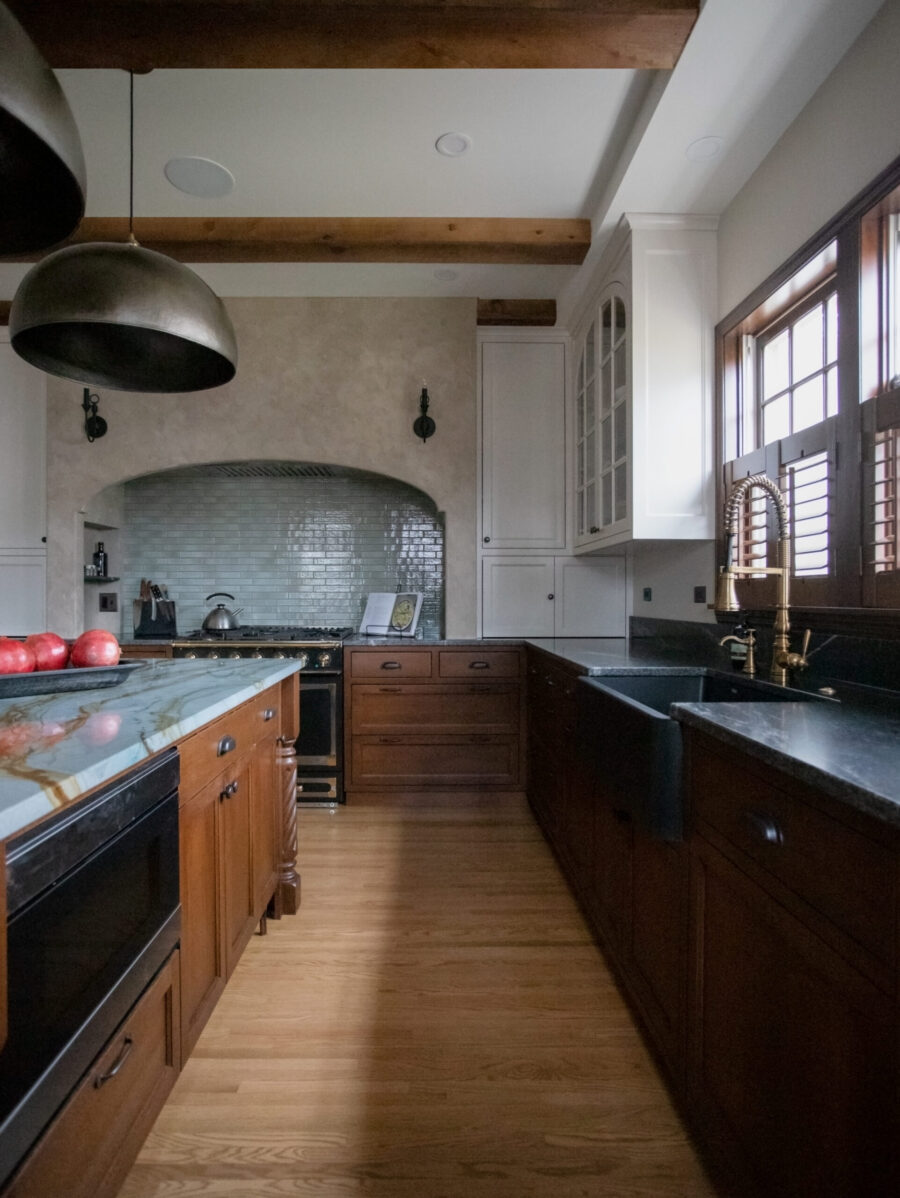 Twin Cities kitchen renovation includes exposed architectural timber, contrasting cabinetry.