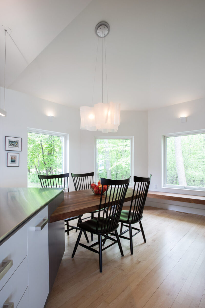 Bright Twin Cities kitchen-renovation: light hardwood, white walls, large rectangular windows.