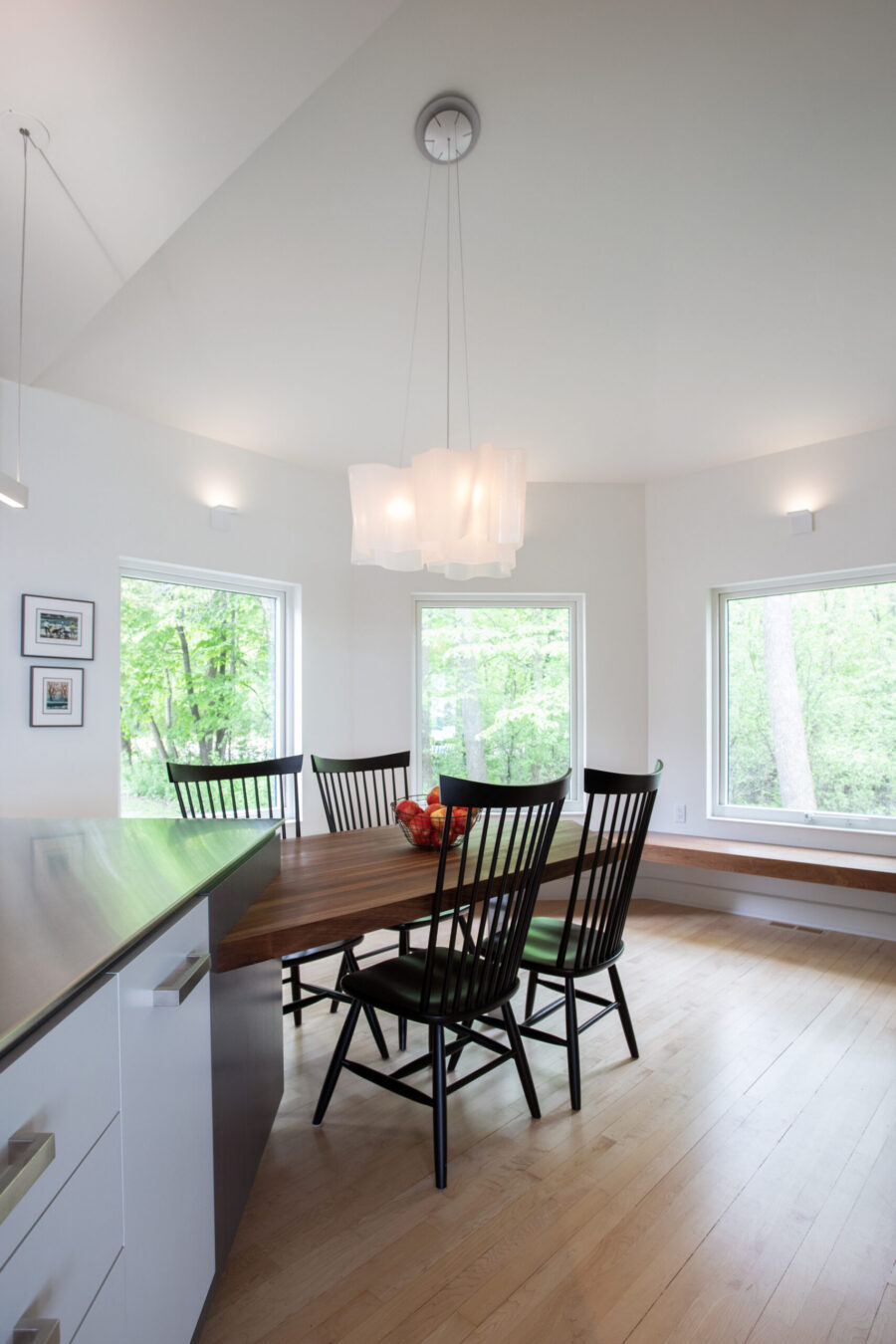 Bright Twin Cities kitchen-renovation: light hardwood, white walls, large rectangular windows.