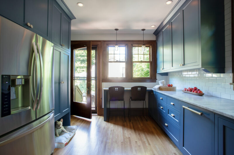 Twin Cities kitchen design-build: blue cabinetry, wood floors, white countertops, tile.
