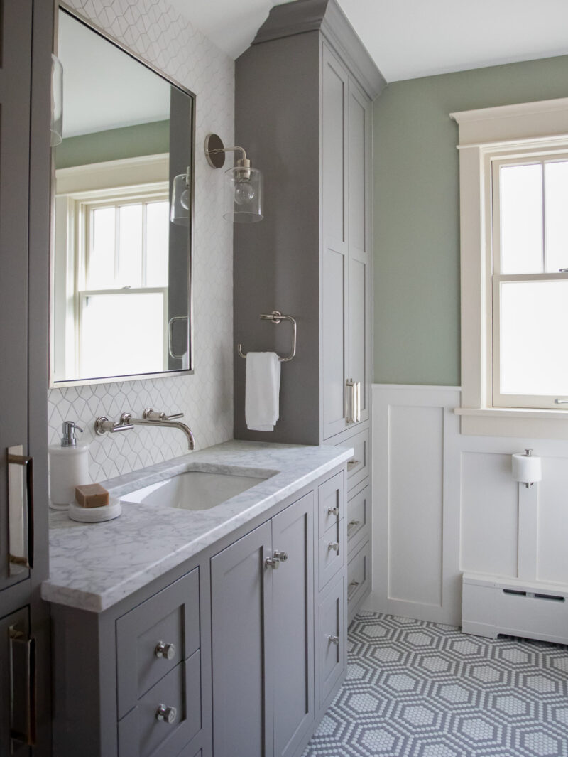Twin Cities bathroom renovation features gray vanity, marble counter, hexagonal floor.