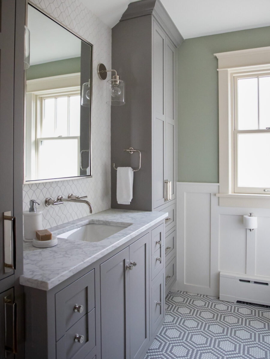 Twin Cities bathroom renovation features gray vanity, marble counter, hexagonal floor.