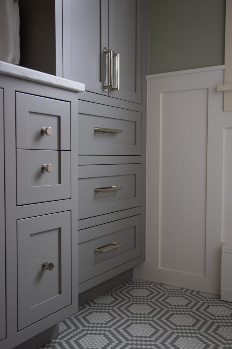 Twin Cities bathroom renovation features gray shaker cabinets, brushed nickel hardware, hexagonal tiles.