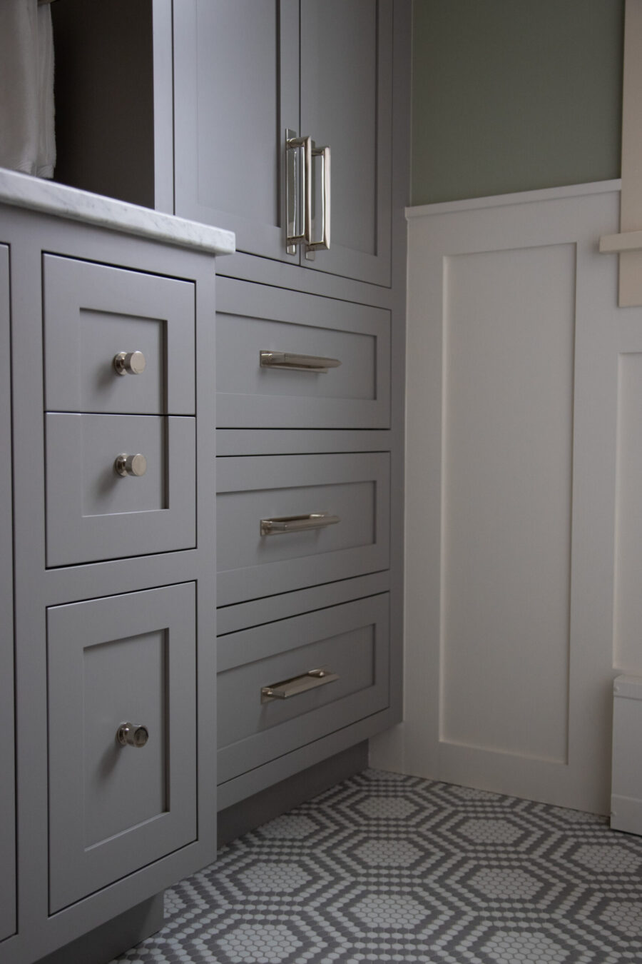 Twin Cities bathroom renovation features gray shaker cabinets, brushed nickel hardware, hexagonal tiles.