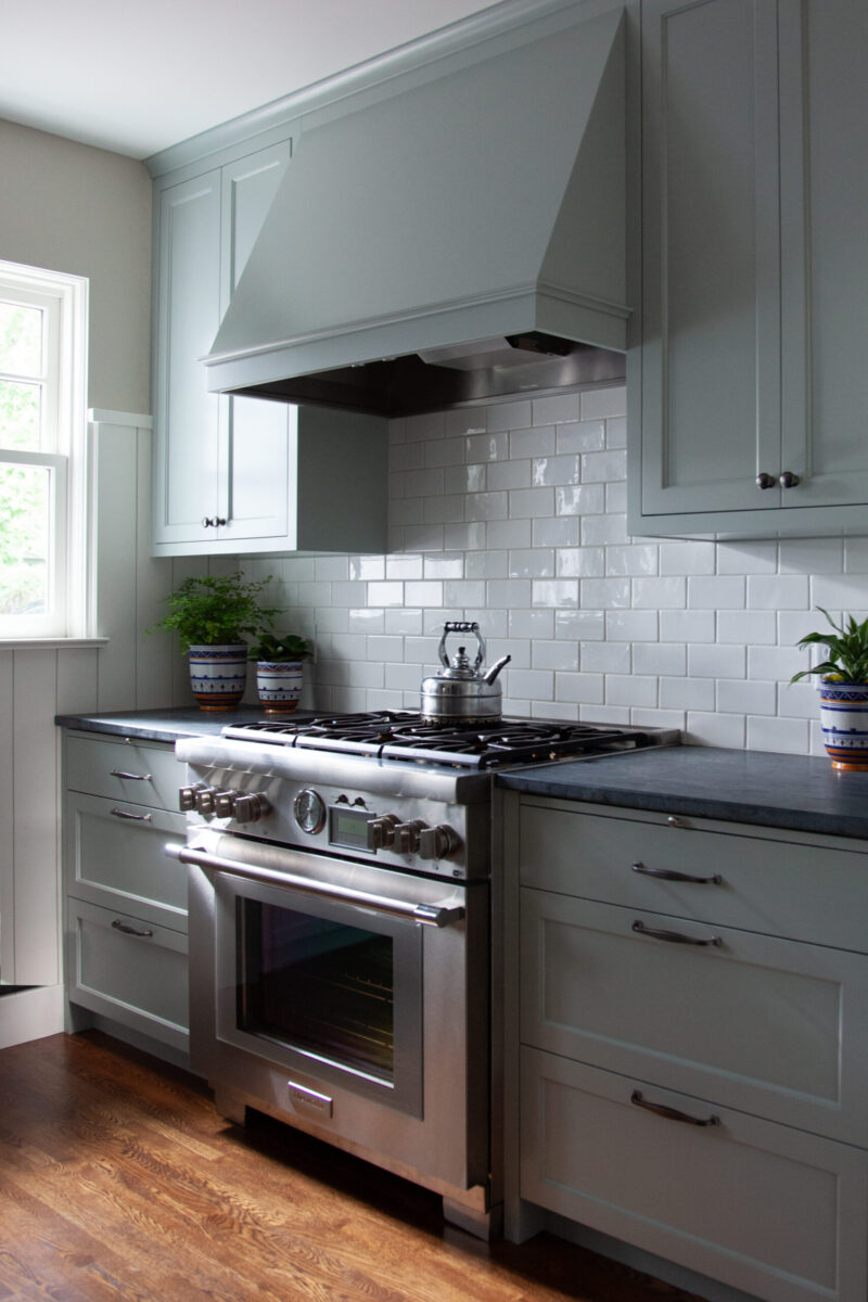 Twin Cities kitchen remodel: light gray cabinets, white tile, stainless range.