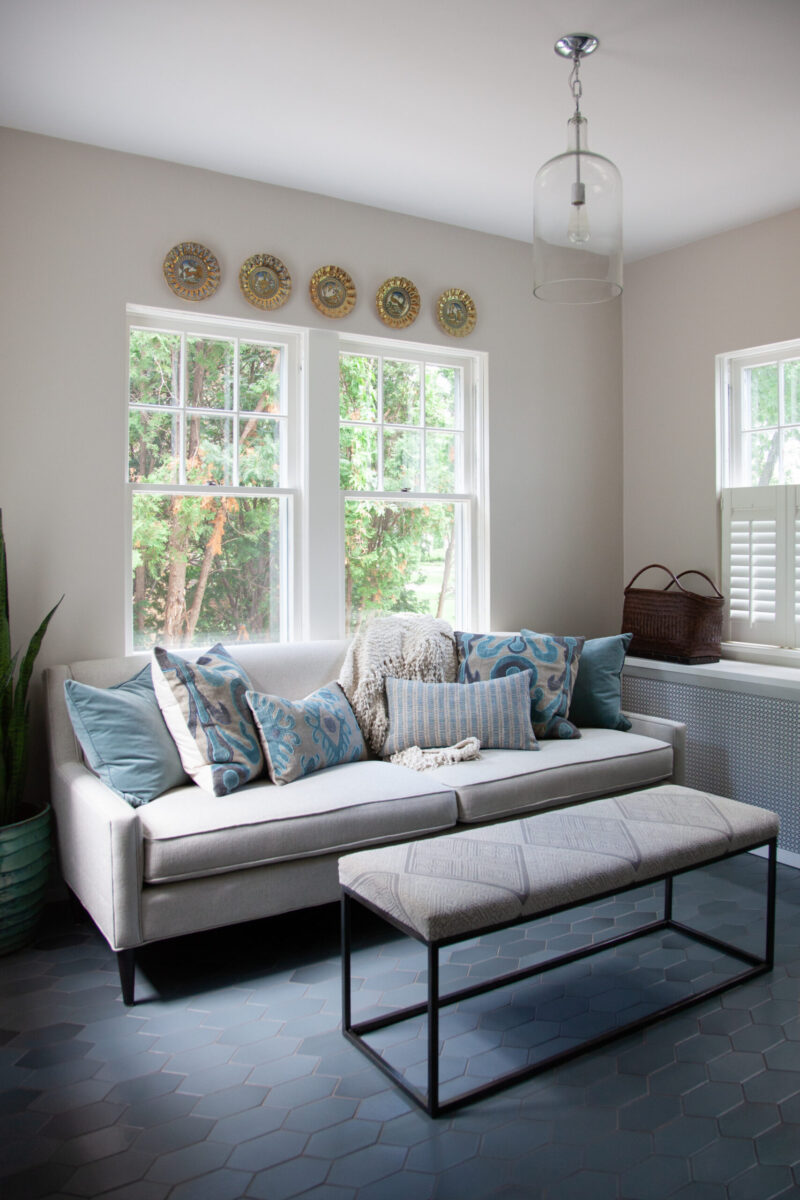 Twin Cities residential renovation presents comfortable grey sofa, hexagonal flooring.