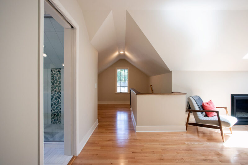 Modern Twin Cities attic renovation features hardwood floors and a striking bathroom remodel.