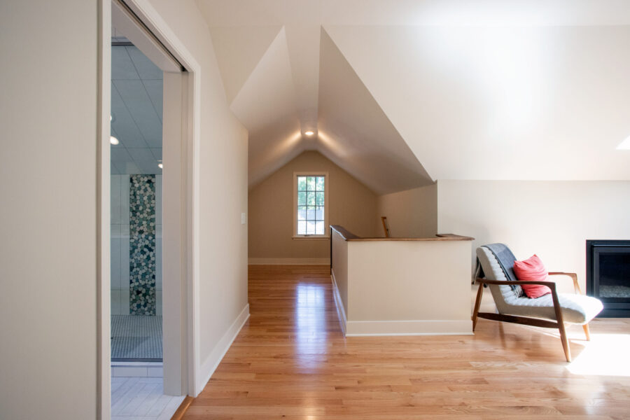 Modern Twin Cities attic renovation features hardwood floors and a striking bathroom remodel.