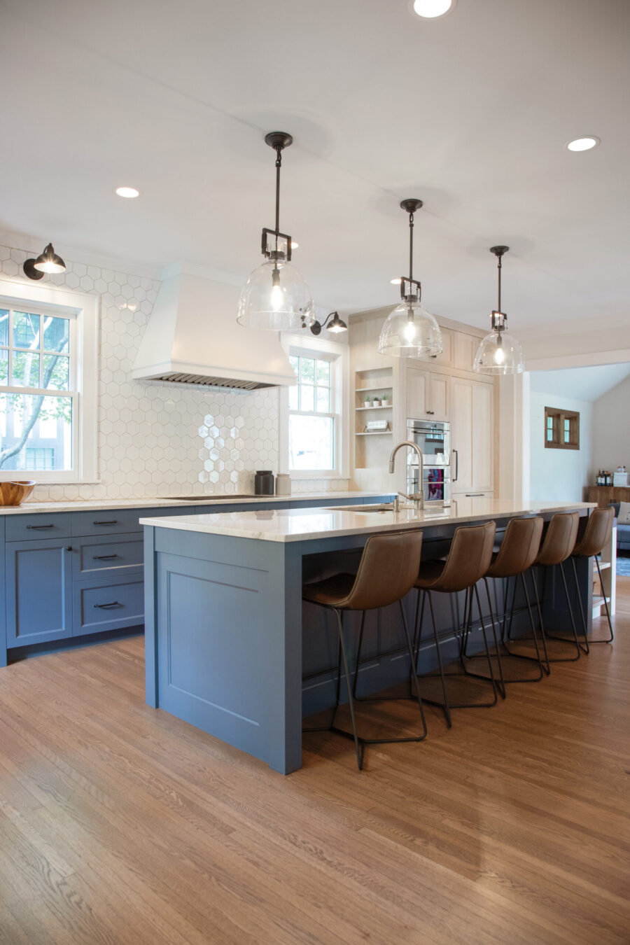 Twin Cities kitchen remodel features blue cabinets, white countertops, hex tile, and wood floors.