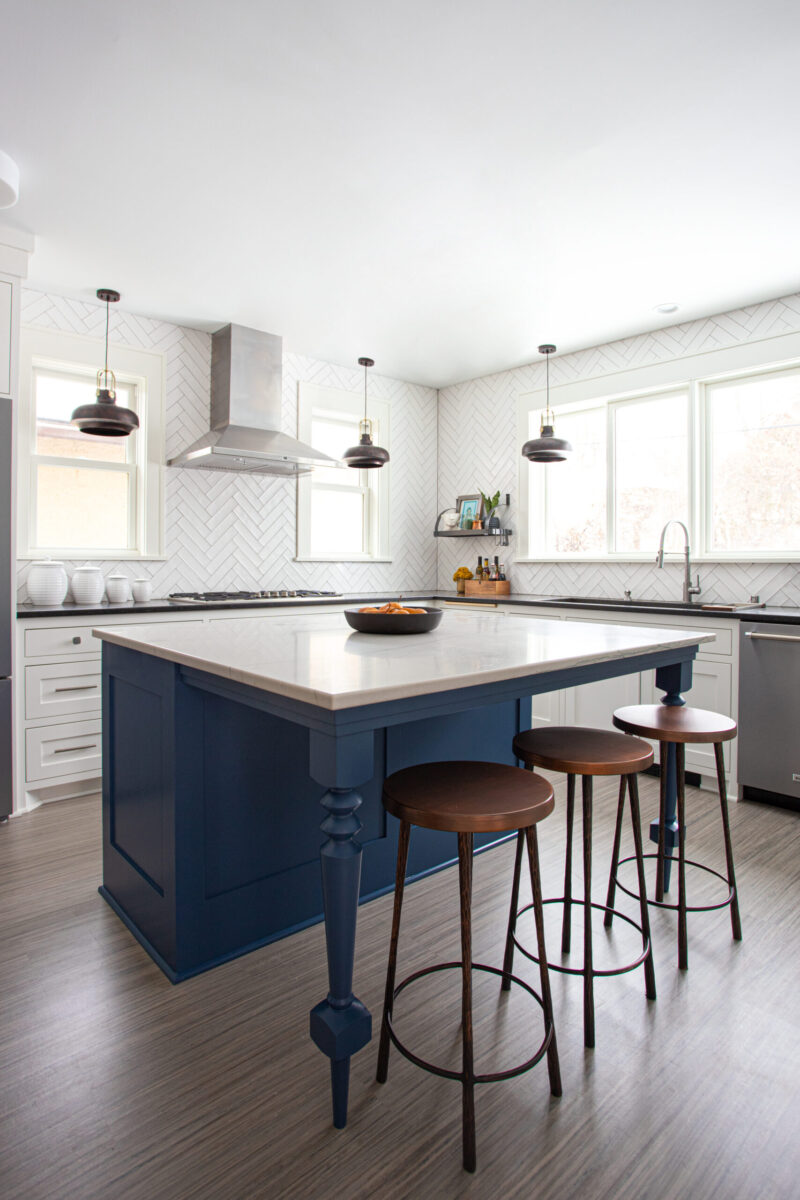 Twin Cities kitchen remodel features blue island, white countertops, herringbone tile.