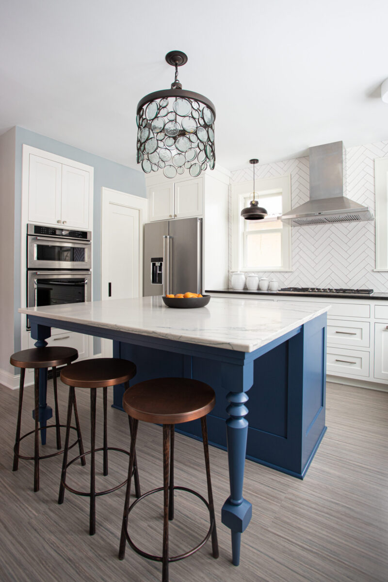 Twin Cities kitchen remodel features blue island, white marble, sleek appliances.