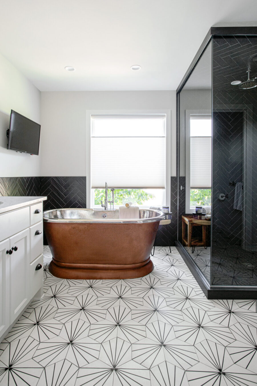 Twin Cities home renovation: copper tub, distinctive floor, dark herringbone shower.