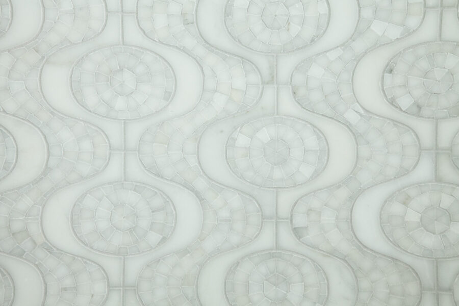 Opaque-white marble mosaic forms elaborate wavy-circular patterns. Bathroom remodel.