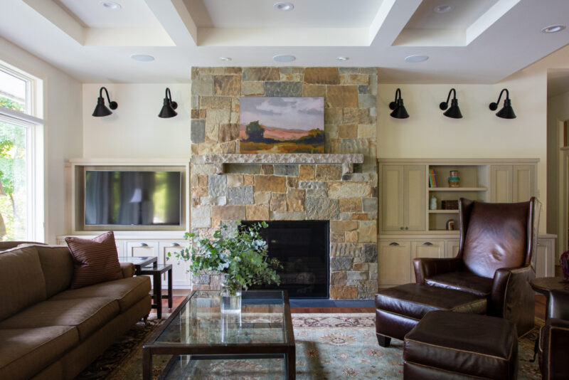 Twin Cities home renovation boasts stone fireplace, custom built-in cabinetry.