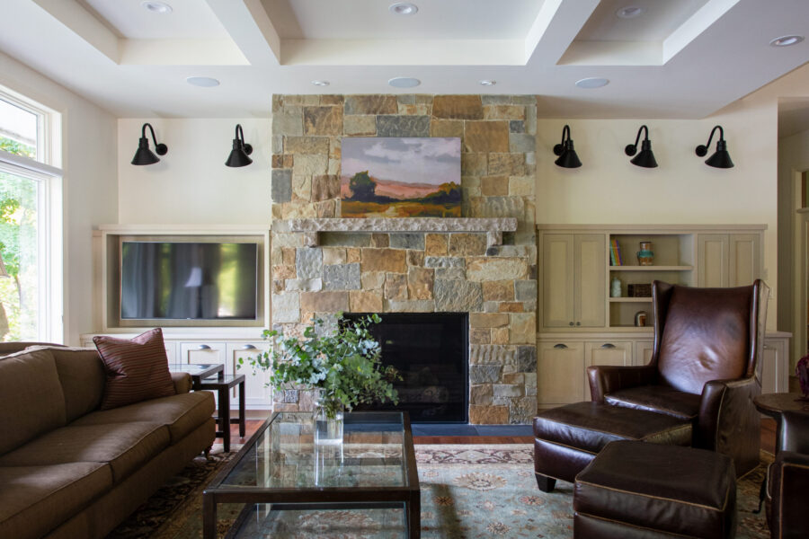 Twin Cities home renovation boasts stone fireplace, custom built-in cabinetry.