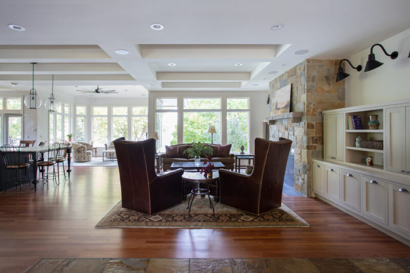 Twin Cities design-build features open-concept interior, stone fireplace, hardwood.