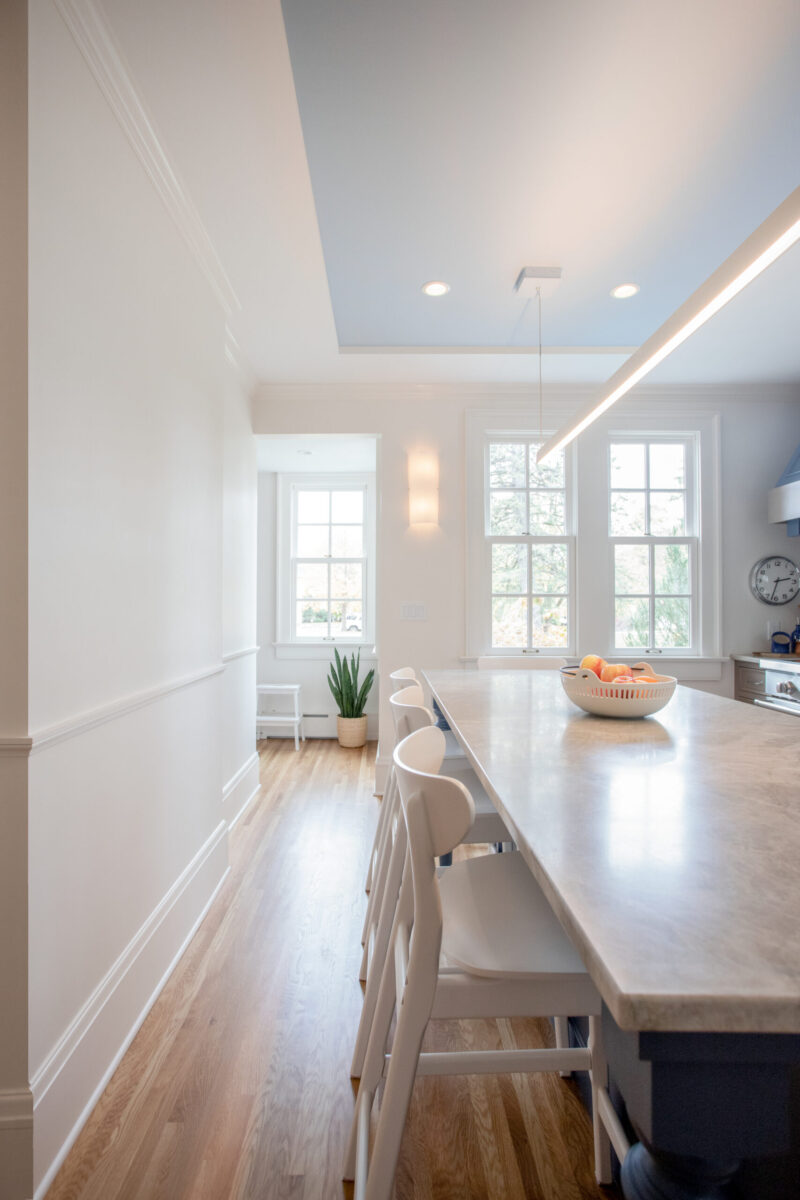 Twin Cities kitchen remodel: extensive marble-look island, contemporary lighting.