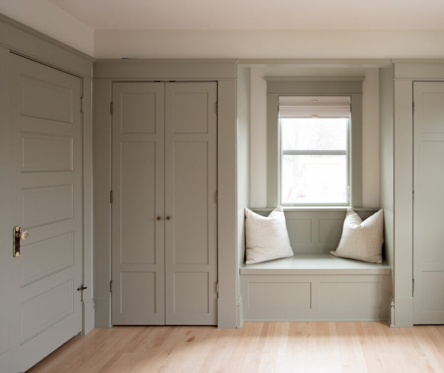 Custom-built sage-green window-seat, paneled cabinetry, Twin Cities remodeling.