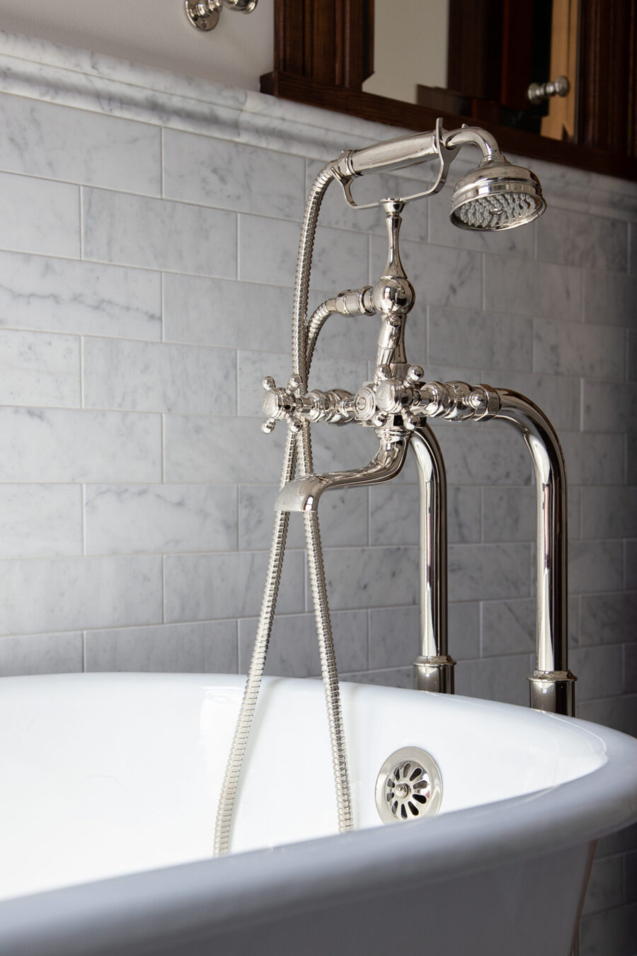 Polished nickel tub filler, classic white marble subway tile bathroom remodel, Twin Cities.