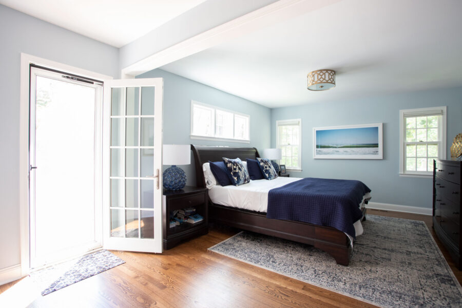 Twin Cities design-build completed serene light-blue bedroom, dark wood floors.