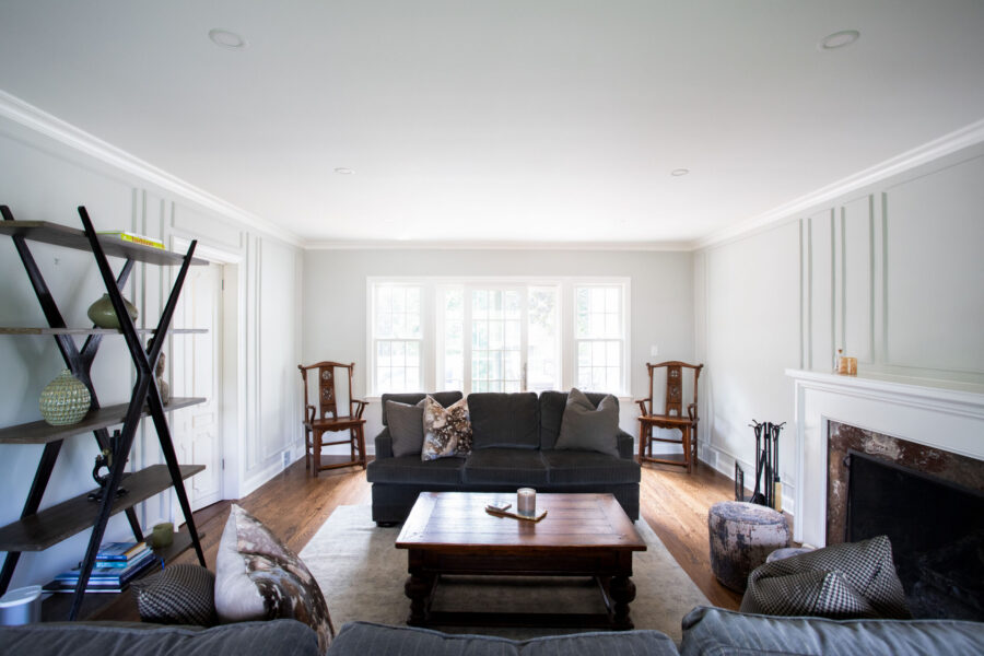 Bright living room renovation: crisp white walls, wood floors, fireplace.