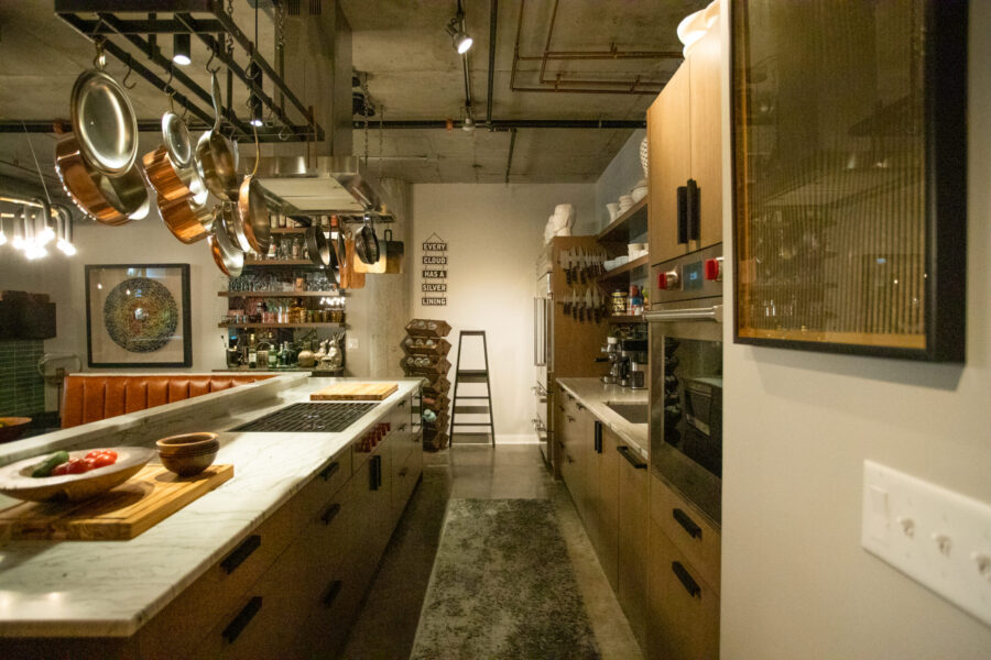 This kitchen remodel blends marble, custom cabinetry, and concrete architecture.